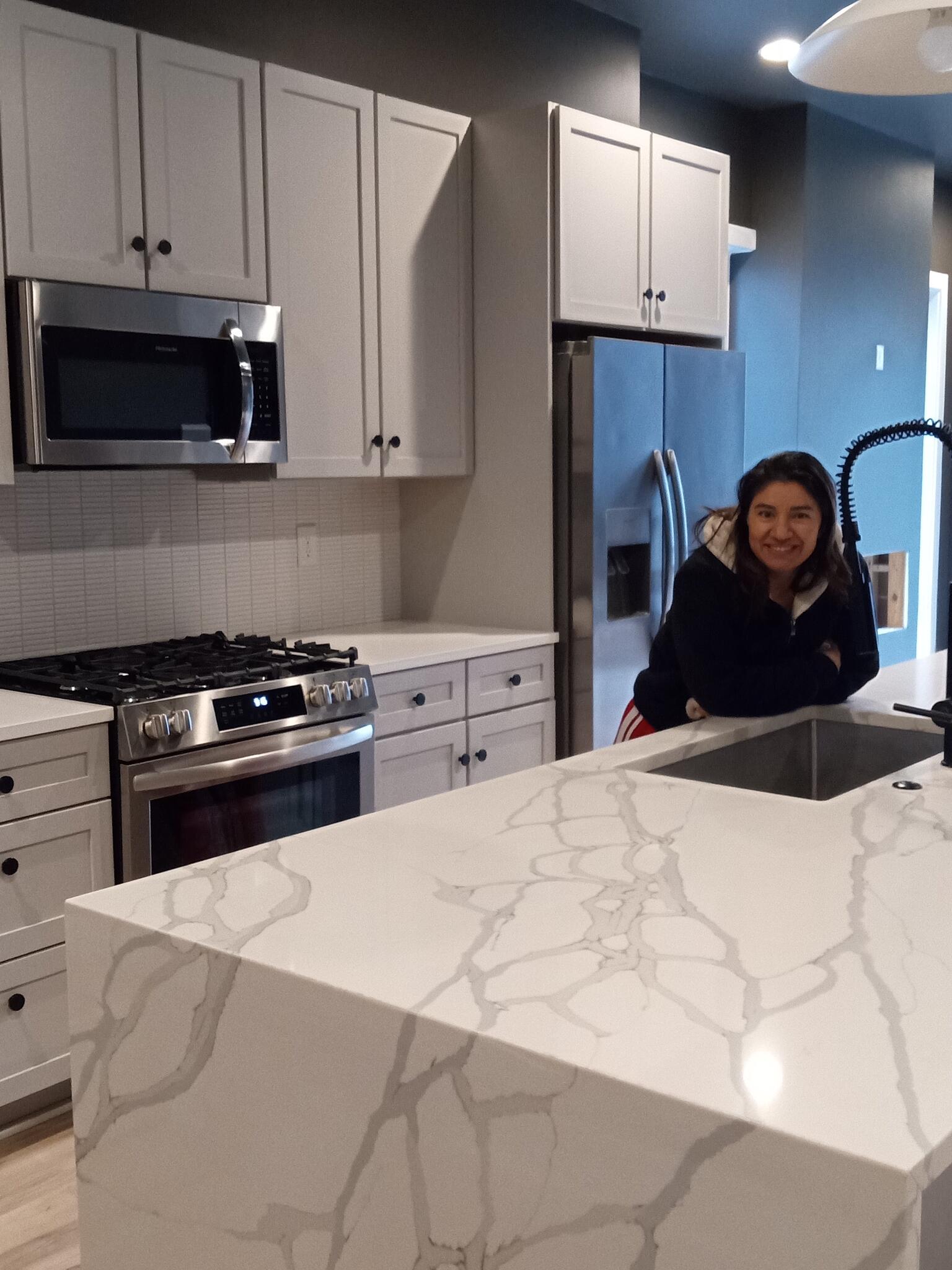 Clean kitchen with white cabinets and a bright counter